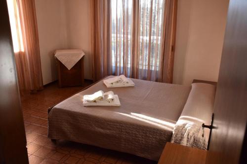 een slaapkamer met een bed met twee handdoeken erop bij Casa Vacanze Ester in Brenzone sul Garda