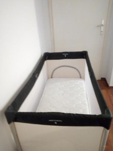 a small room with a black and white bed at Two bedroom apartment near centre in Ohrid