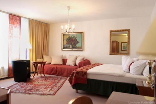 ein Hotelzimmer mit 2 Betten und einem Sofa in der Unterkunft Landhotel Furthmühle in Grabe