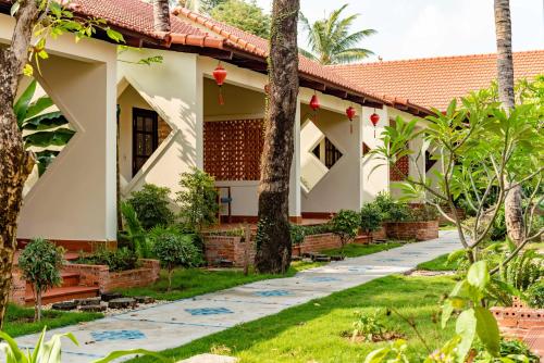 a house with a garden and a pathway at Hula Hula Seafront Phu Quoc in Phu Quoc