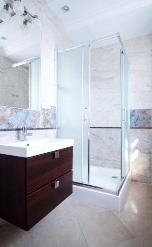 a bathroom with a glass shower and a sink at roomsy guest house in Sopot