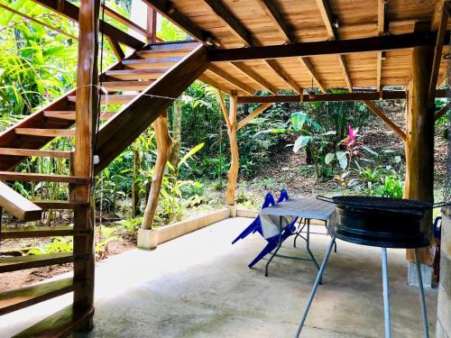 a table and a chair under a pergola at Tranquila in Manzanillo