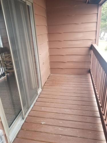 a wooden deck with a wooden door leading to a balcony at St. Croix Inn in Solon Springs
