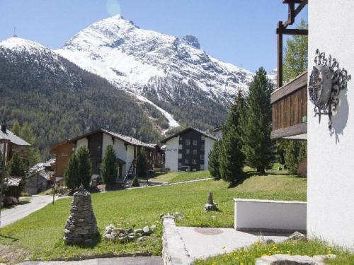 a village with a snow covered mountain in the background at Apartment Amici 20 by Interhome in Saas-Fee