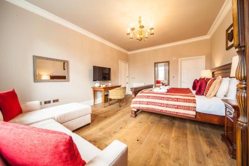 a large bedroom with a bed and a couch at The Manor at Bickley in Bromley