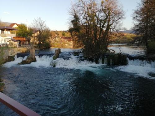 a river with rapids and waterfalls at Amina River Apartment in Bihać
