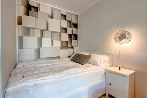 a bedroom with a bed with a large wooden headboard at Prime Apartments - Lazurowa Przystań II in Sopot