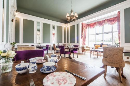 a dining room with a table and chairs at The Manor at Bickley in Bromley