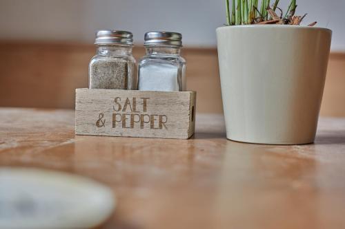 two salt and pepper bottles sitting on a table at Ca n'Alexandre - Adults Only in Palma de Mallorca