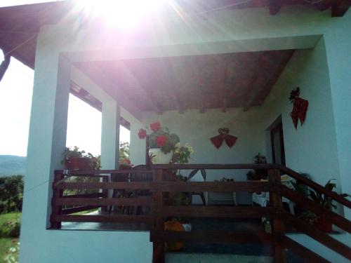 a balcony of a house with a vase of flowers at Pensiunea La Poarta Bucovinei in Suceava