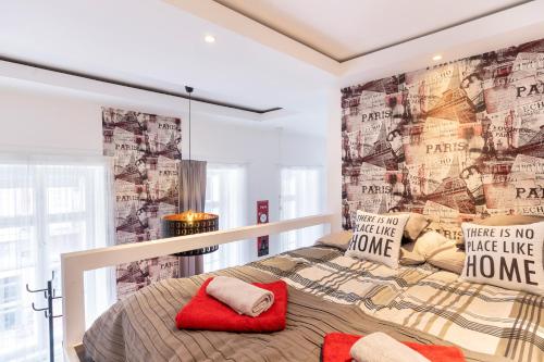 a bedroom with a bed with a wall covered in posters at King Beautique Resort in Budapest