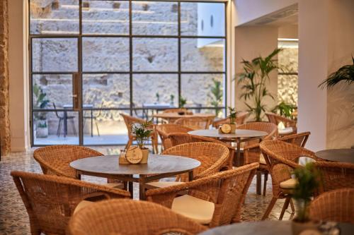 a restaurant with tables and chairs and a large window at Ca n'Alexandre - Adults Only in Palma de Mallorca