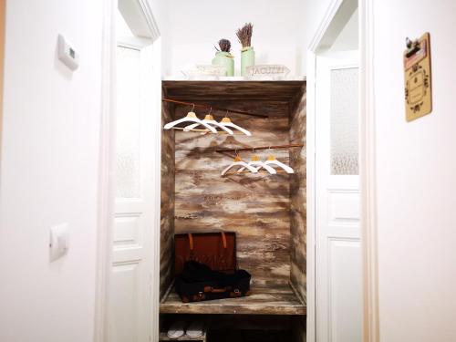 a walk in closet with white doors and shoes at Suite Inn Centro Dimora Storica in Enna