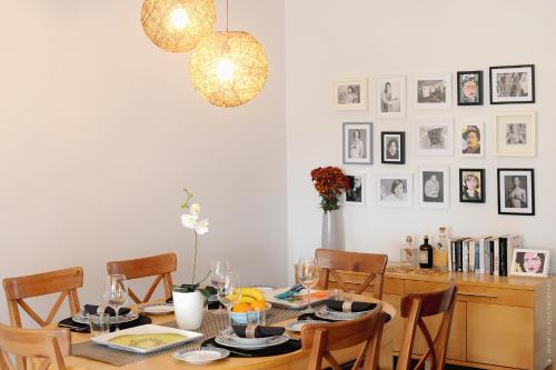 a dining room table with chairs and a chandelier at Apartamento Quinta do Faial in Funchal