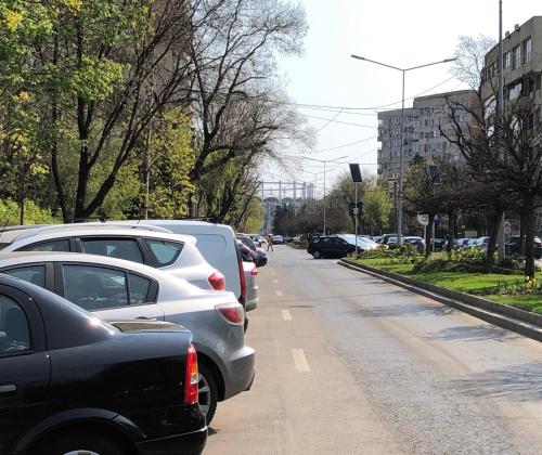 a bunch of cars parked on the side of a street at Cozy and Clean Apartment, near National Arena in Bucharest