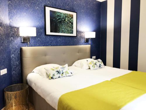 a bedroom with a bed with two pillows at Hotel Les Suites - Domaine de Crécy in Crecy la Chapelle