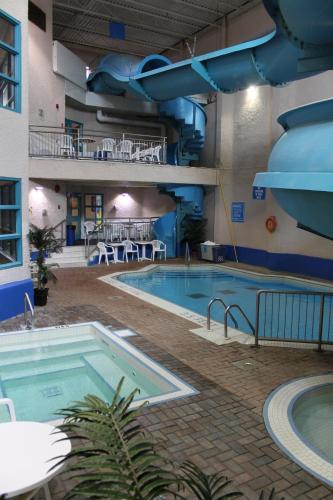 a large swimming pool in a large building at Travelodge by Wyndham Brandon in Brandon
