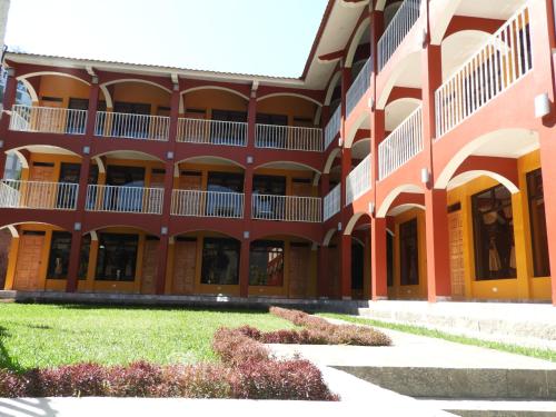 a large building with a grass yard in front of it at Hotel Adulam in San Pedro La Laguna