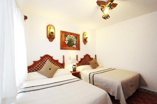 Ein Bett oder Betten in einem Zimmer der Unterkunft Hotel Mesón del Rosario