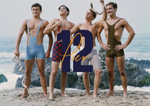 a group of men standing on the beach at Pier12 in Eastbourne