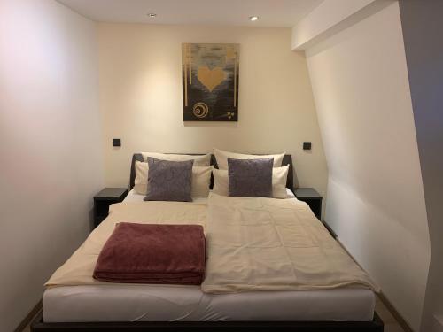 a bedroom with a large bed with two pillows at Hotel Friedrich in Hachenburg