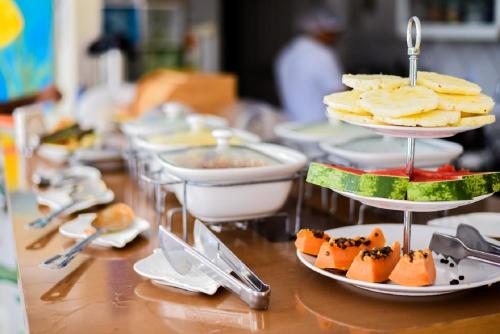 a table topped with plates of food on a table at Recanto do Aconchego in Porto De Galinhas