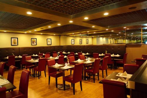 a dining room with tables and red chairs at BEST WESTERN PLUS Hotel Hong Kong in Hong Kong
