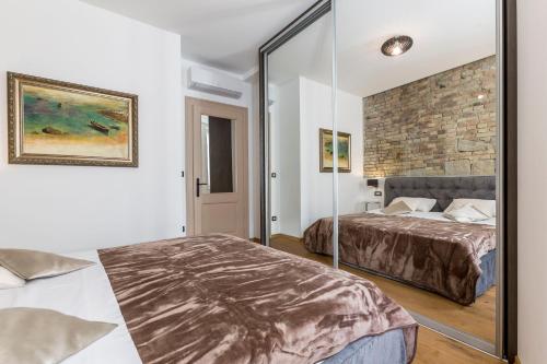 - une chambre avec 2 lits et un miroir dans l'établissement Queen Apartment, à Split