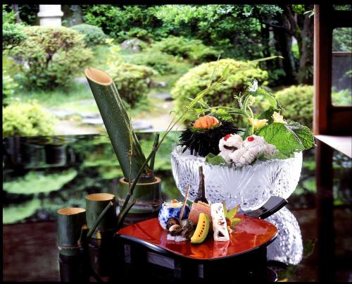 a potted plant sitting on top of a table at Nishimuraya Honkan in Toyooka