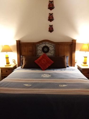 a bedroom with a large bed with two lamps at Teocalli in Teotitlán del Valle