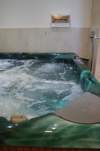 a large pool of water in a room at Domus Mariae Benessere in Siracusa