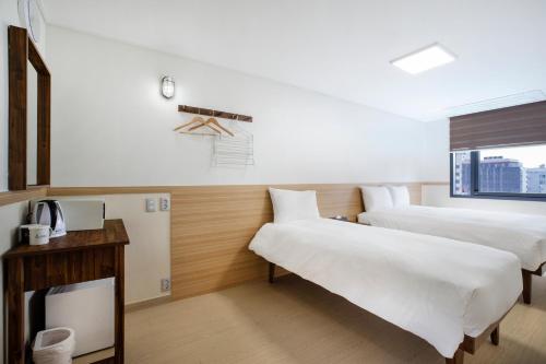 a hotel room with two beds and a window at Five hotel Jongno in Seoul