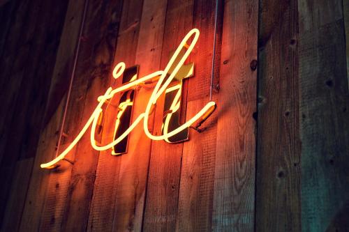 a neon sign that says the end on a wooden wall at Hotel It Osaka Shinmachi in Osaka