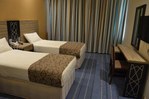 Ліжко або ліжка в номері فندق الماسة الروضة