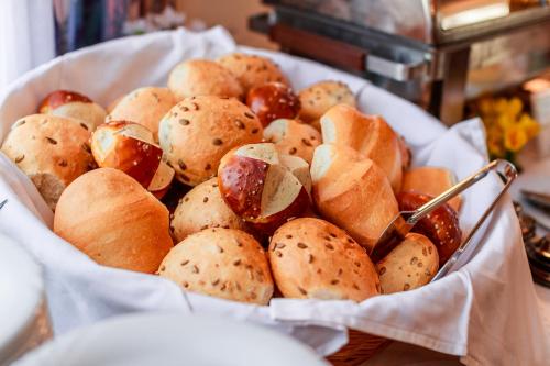 a basket filled with lots of different types of buns at PLAZA INN Blankenburg Ditzingen, Sure Hotel Collection in Ditzingen
