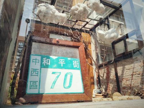 a store window with a sign in front of a building at GOIN Old House & Bar in Tainan