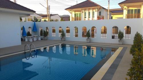 a swimming pool in front of a house at Cozy House in Hua Hin, Thailand in Hua Hin