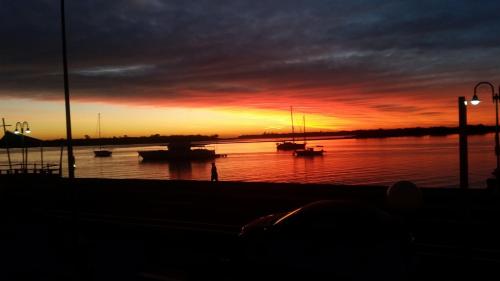 a sunset over a river with boats in the water at Beaconlea in Gold Coast