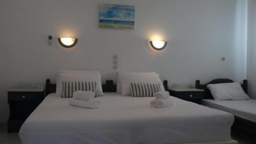 a bedroom with two beds with towels on them at Blue & Sea Studios Apartments in Drios
