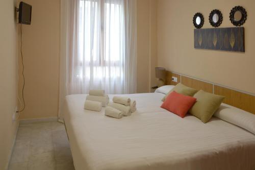 Postel nebo postele na pokoji v ubytování Apartamentos Casa-Patio Las Palmeras