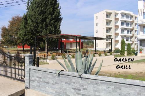 a gazebo in a park next to a building at Apartments Perezaj II in Ulcinj