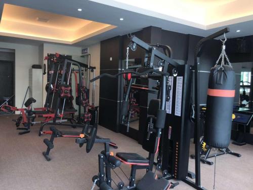 a gym with a bunch of equipment in a room at Qu Lin Resident in Sibu