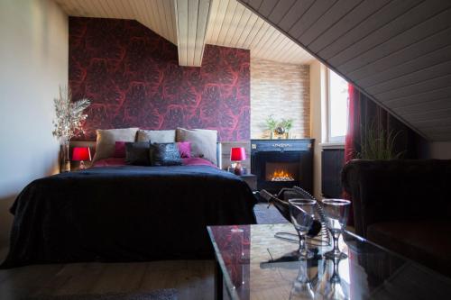 a bedroom with a bed and a fireplace in it at Glamour in Budapest