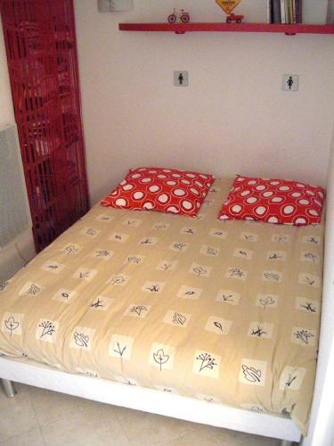 un lit dans une petite pièce avec dans l'établissement Agréable appartement 4 personnes à Villeneuve-Loubet Plage, piscine, mer, commerces à proximité, à Villeneuve-Loubet