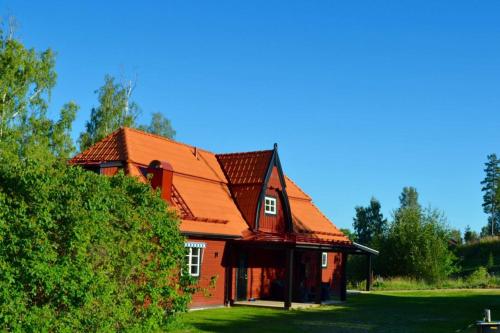 a large red house with a red roof at Dalecarlia Hotel & Spa, BW Premier Collection in Tällberg