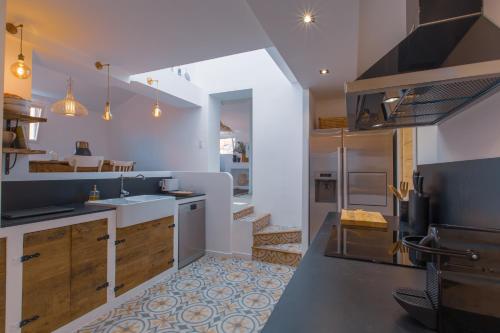 a kitchen with a sink and a stove top oven at Ze Perfect Place - Vieux Nice - Exceptionnel Appartement - Calme et Terrasse avec vues in Nice