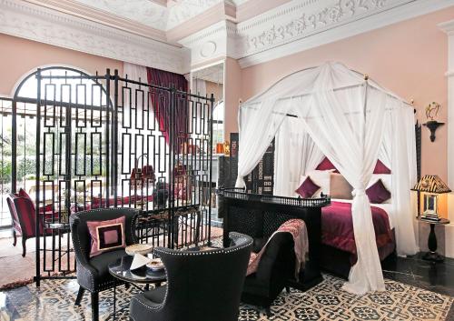 a bedroom with a bed with a canopy at Palais Ronsard Relais & Chateaux in Marrakesh