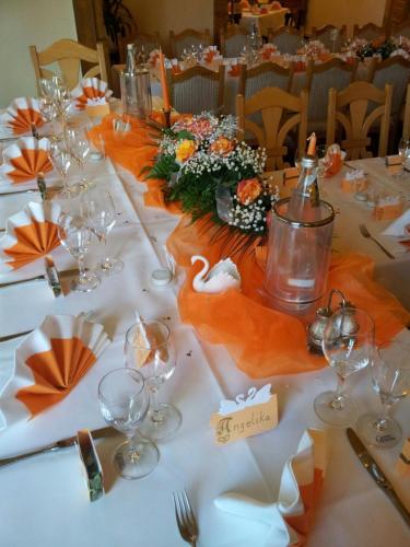 a long table with wine glasses and a swan on it at Hotel Wippertal - voll klimatisiert in Bernburg
