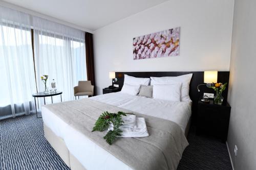 a hotel room with a bed with a christmas wreath on it at Wellness Hotel Vista in Dolní Morava
