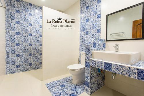 a blue and white bathroom with a toilet and sink at La Reina Maroc Hotel ปากช่อง เขาใหญ่ in Pak Chong